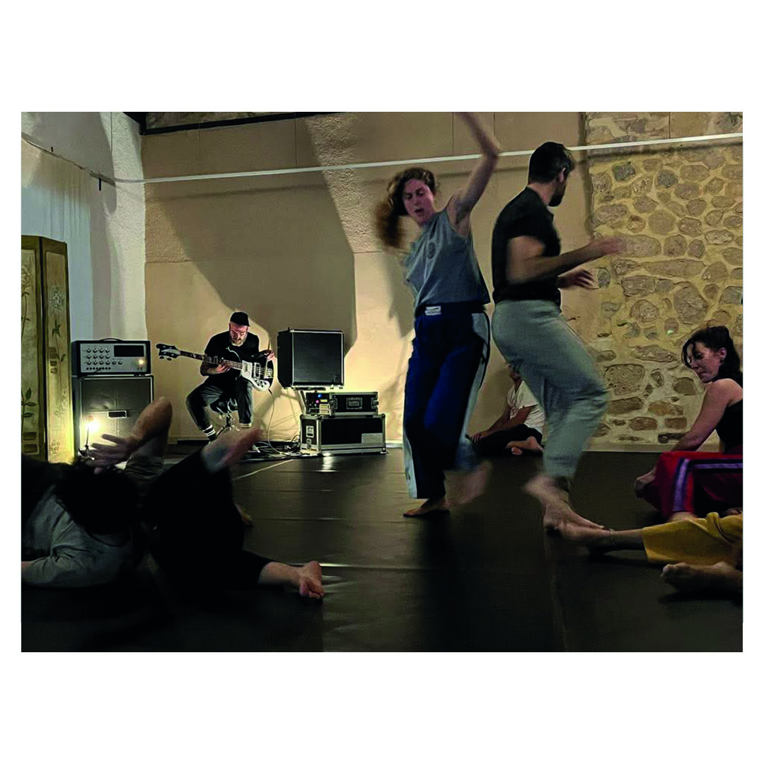 Two participants dancing during a collective improvisation with frise lumière at To Mikro Studio in Aegina
