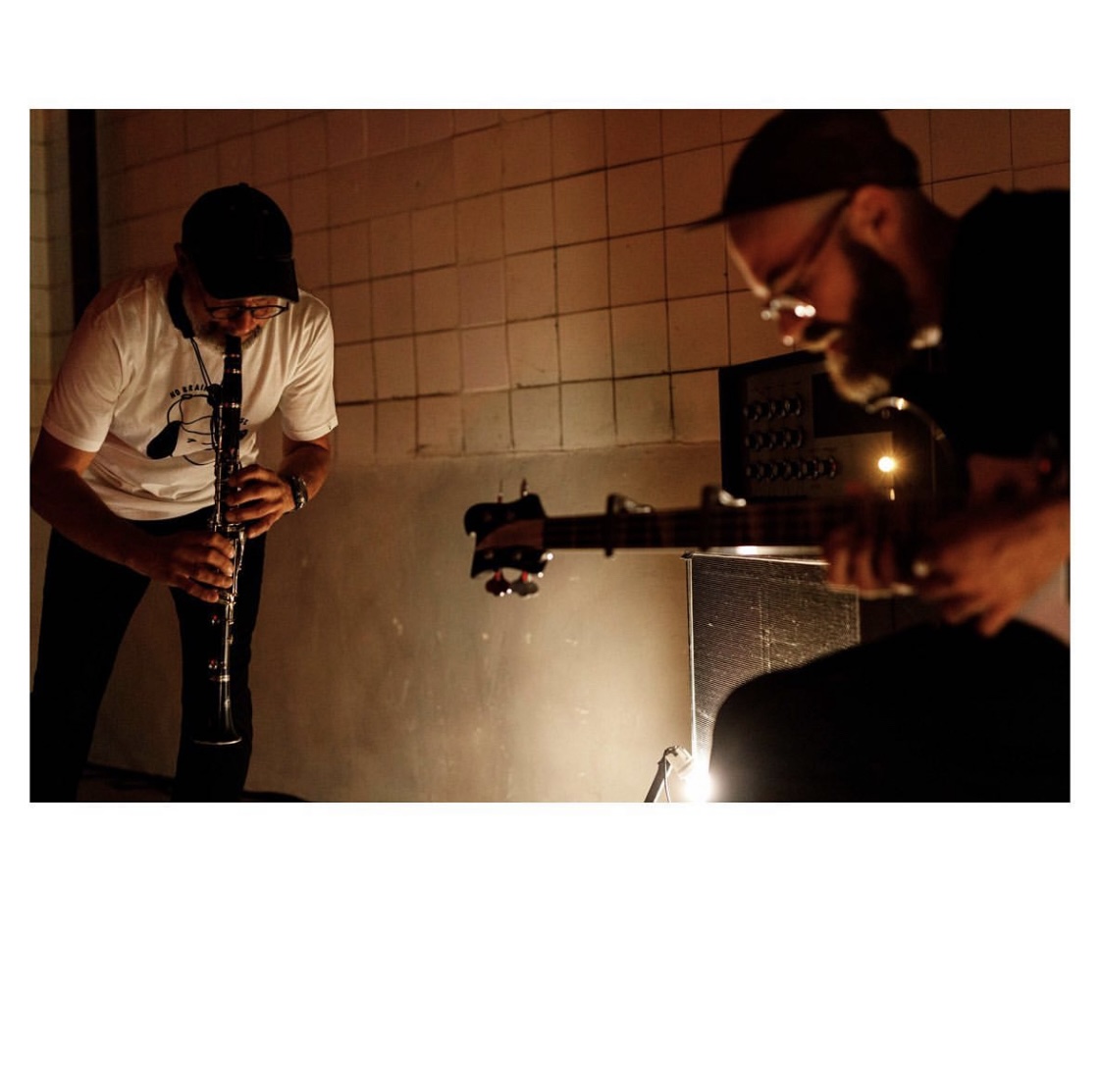 Michał Sikorski playing clarinet with Ludovic Gerst as frise lumière at Galeria Exit in Wrocław